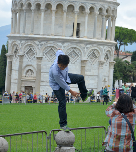 Some tourists risk head and neck for a good photo with the leaning tower