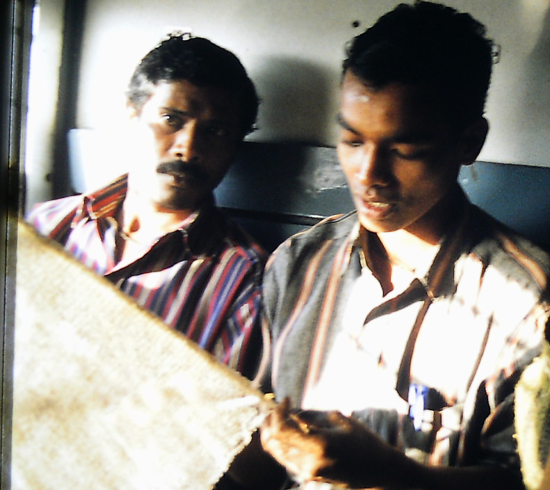 Indian Fishermen in the train from Goa to Hospet knotting nets