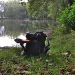 Camera bag with DSLR camera on top outdoor at a lake
