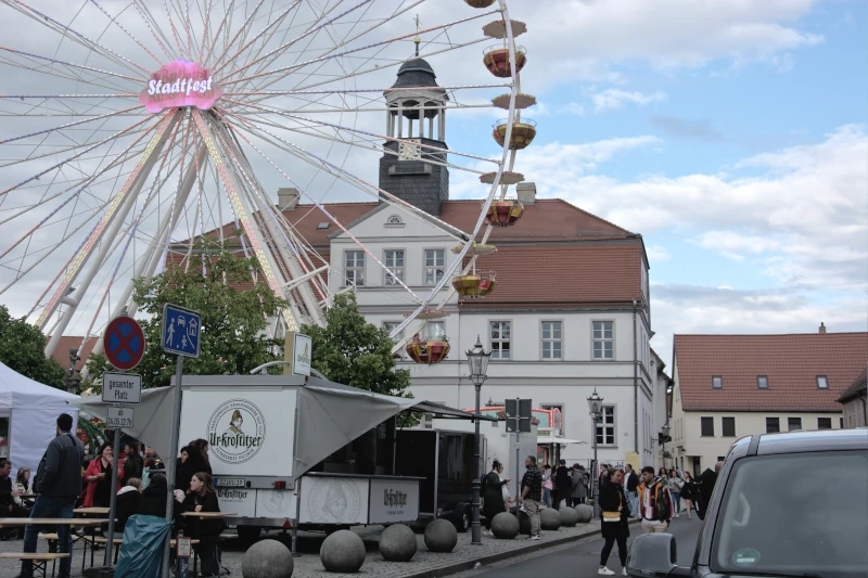 Town hall Bad Düben with goat clock and Ferris wheel from the town festival in June