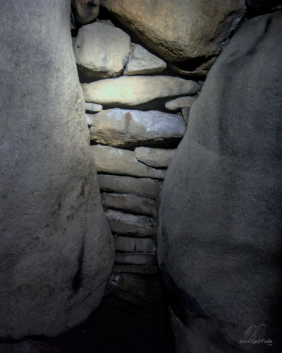 stone package between supporting stones in the wall of the gave chamber Mårhøj passage grave at Funen island, Denmark